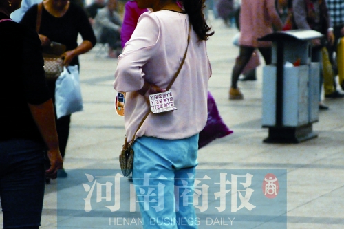 火車站廣場，一女子拿著寫有不同房型價位的卡片在拉客，不少市民抱怨，受過此類“騷擾”