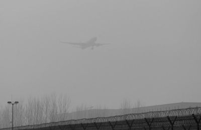 在首都機(jī)場(chǎng)，飛機(jī)在霧霾中降落。