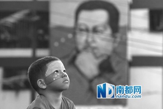 3月5日，一名委內(nèi)瑞拉兒童仰望天空，他身后是查韋斯的陵墓。