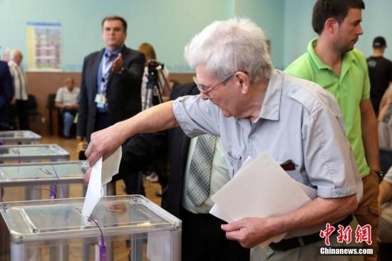 　5月25日，一名烏克蘭選民把填好的選票投入選票箱。
