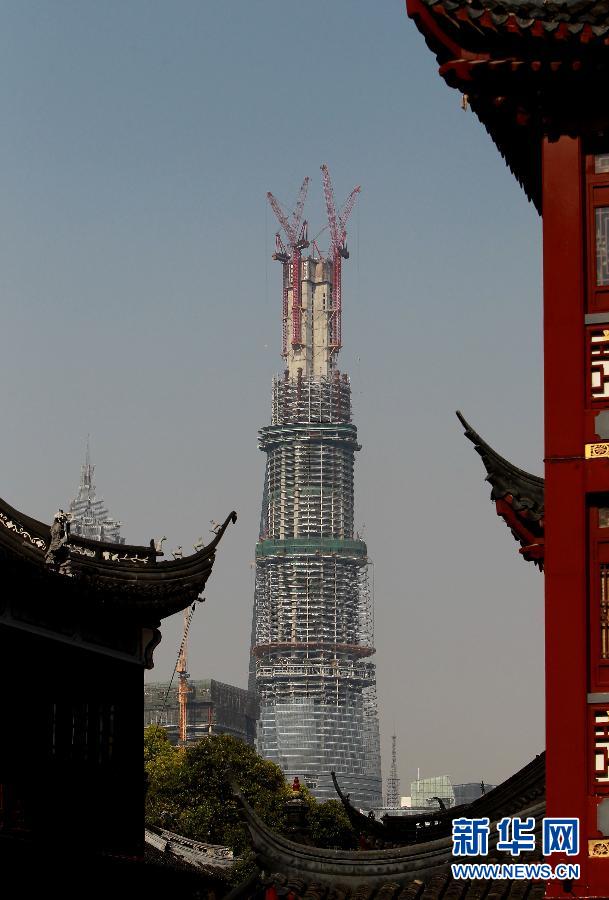 在上海豫園遠眺在建的國內(nèi)第一高樓“上海中心”（4月11日攝）。
