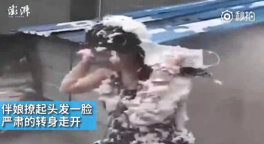 視頻中可以看到，雖然伴娘事先有穿雨衣防備，但在被伴郎團(tuán)圍攻時，雨衣被拔下，更過分的是，有人還用滅火器直接對著她的臉噴。后來伴娘好像是生氣了，撩起頭發(fā)一臉嚴(yán)肅的轉(zhuǎn)身走開。