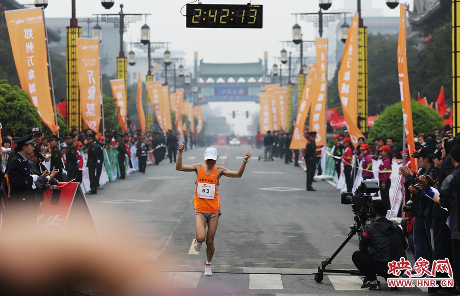 一名選手抵達終點后，高舉雙手慶祝。
