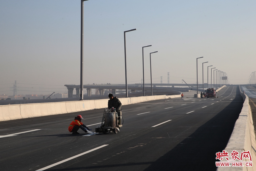 部門路段工人正在噴畫道路標線。
