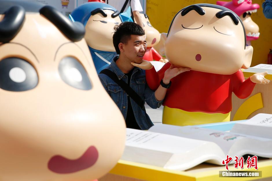 4月22日，游客與蠟筆小新合影?！跋灩P小新25周年紀念特展”日前在北京開展，吸引了不少市民游客。